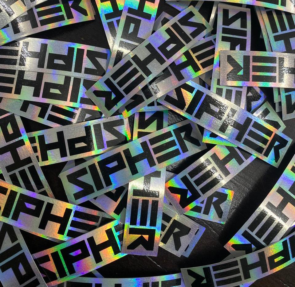 A set of hologram labels with a distinctive, reflective design, showcasing a company logo. These labels are used for security applications to protect products, indicate tampering, and promote branding. Contact information for personalized requests is provided: email print@arrowprint.ca or call 519 532 7065.
