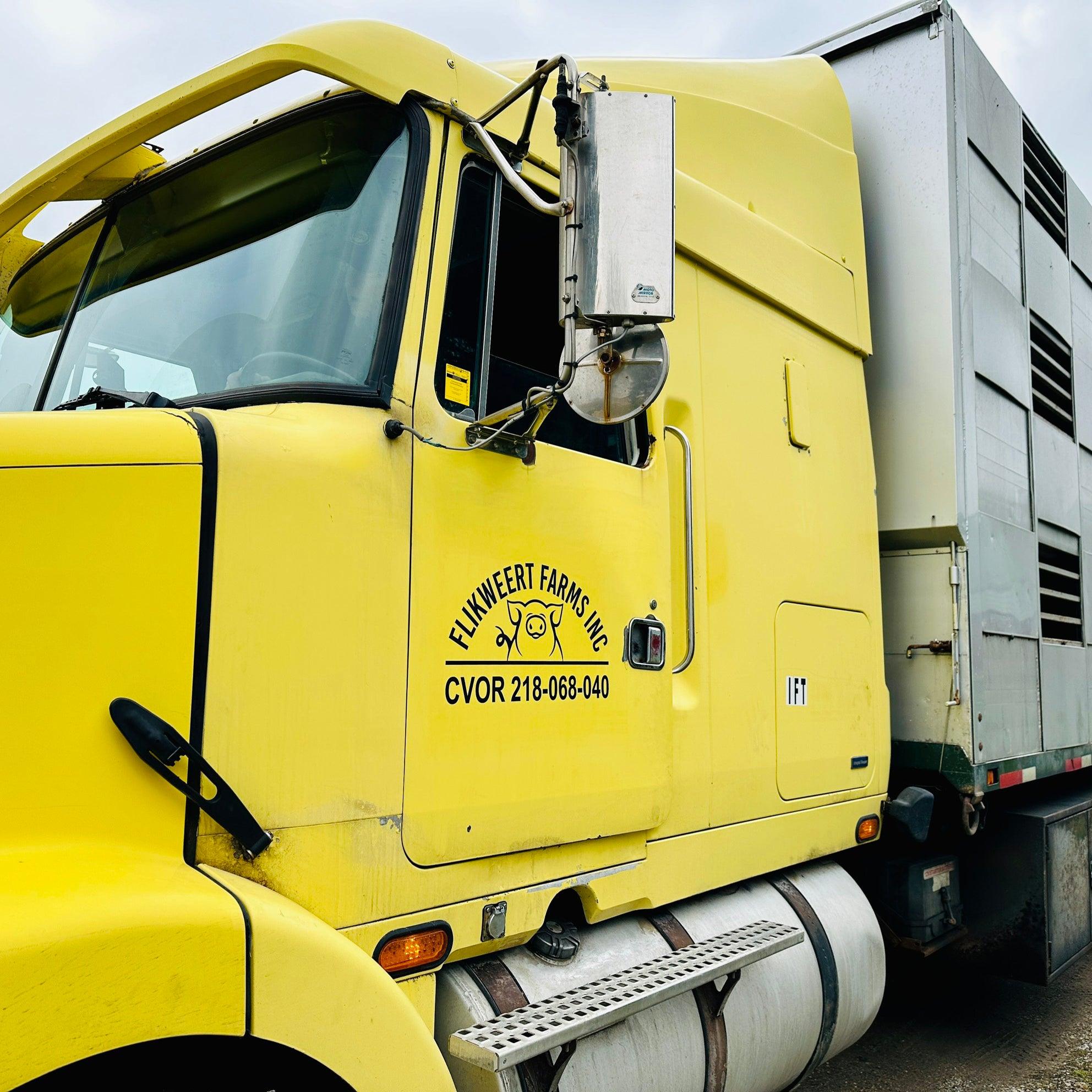 Custom vinyl decal lettering on a truck featuring a cheerful pig icon, designed by arrowprint.ca to add a playful and professional touch to your vehicle.