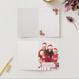 Holiday greeting card with family photo on a white surface with decorative elements.