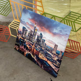 Custom canvas prints from Arrow Print Canada displayed in various sizes, showcasing vibrant colors and sharp details. The prints are stretched over sturdy wooden frames, adding a personal touch to any room. Contact information for custom requests is provided.